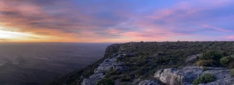 A broad panorama of the sandstone krans under a changing sky